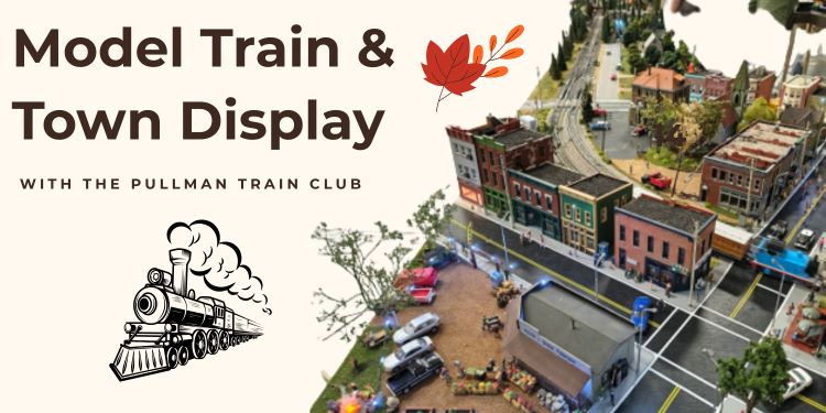 banner for the model train & town display program. Model town sits angled to the right.